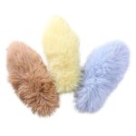 Three fuzzy catnip kicker pillows in brown, yellow and blue arranged on a white background.