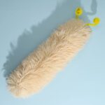 Cream caterpillar catnip toy close up on a blue background.