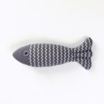 Grey striped fish cat toy with zigzag pattern on a white background.