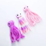 Three soft and colorful Plush Catnip Octopus Toys in pink, purple, and multicolored designs, perfect for playful cats.